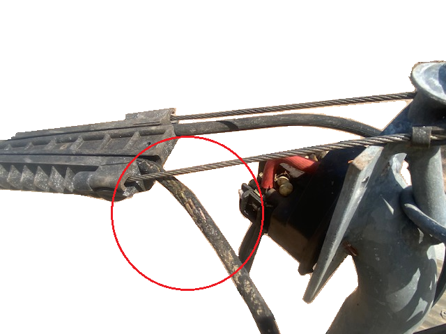 Figure 1: Damaged insulation on overhead power line making contact with stainless steel braided wire.