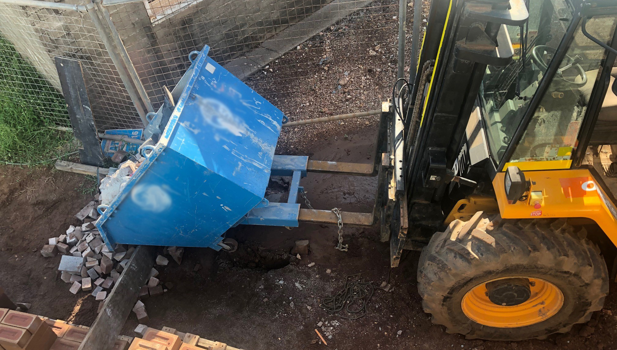 The image of the forklift shows the tines were not fully inserted into the bin pockets.