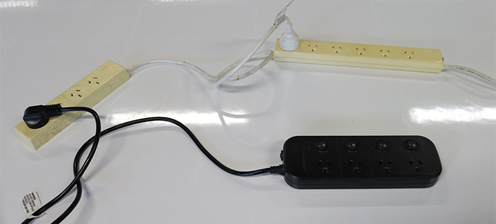 The image shows three domestic power boards plugged into each other to form a chain.