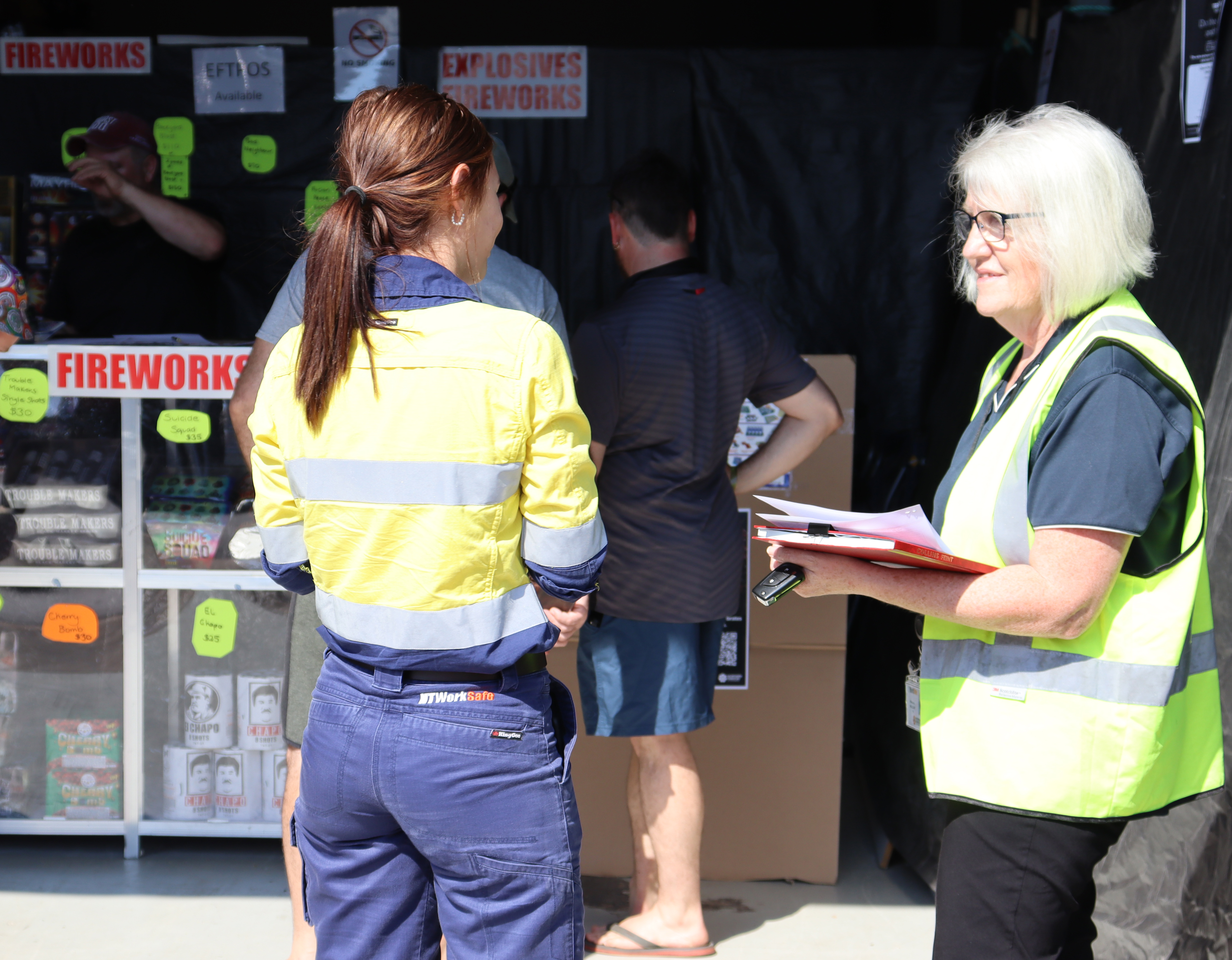 WorkSafe Inspectors conduct checks on Territory Day to ensure retailers and wholesalers are complying with the Dangerous Goods legislation. Image shows two WorkSafe Inspectors conducting a retail check.