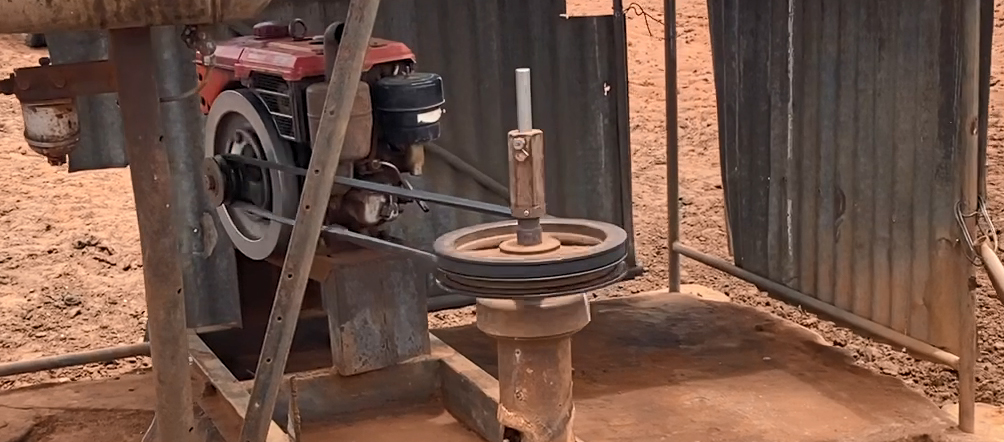 Image 1: The pump’s moving pulleys and belt unguarded, are a hazard for nearby workers. (Source: NT Police) The image shows a bore pump with the moving pulleys and belt unguarded. (Source: NT Police)