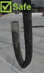 Fold the end of the delivery hose to prevent concrete falling out and air entering the hose. Image shows a delivery hose folded over to prevent concrete falling out.
