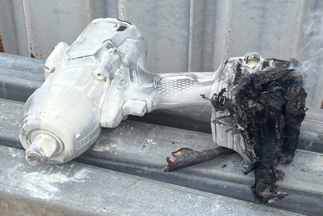 The image shows the still smoking lithium-ion battery after being extinguished by a dry power extinguisher. The image shows the still smoking lithium-ion battery after being extinguished by a dry power extinguisher.