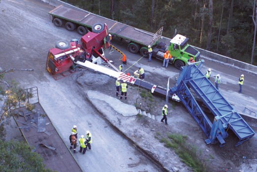 The toppled crane at the incident site. Image shows a mobile crane toppled onto its side